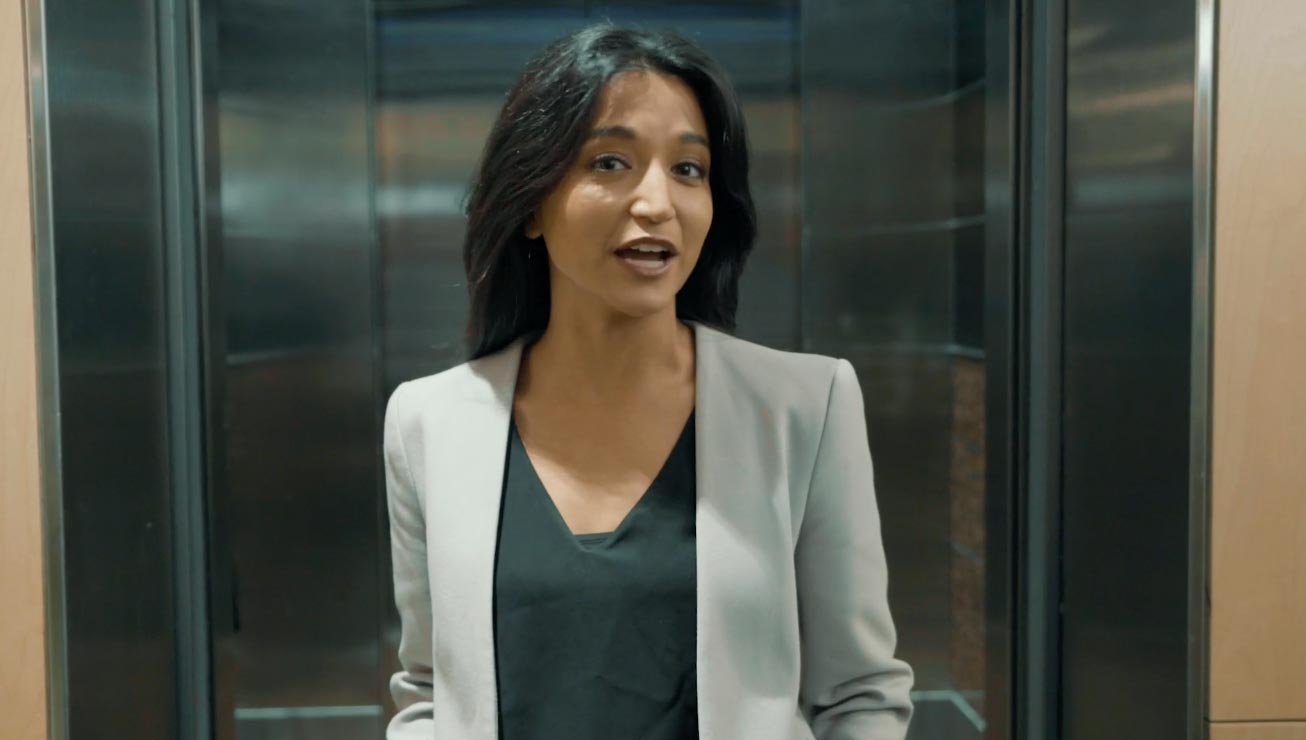 Professional woman speaking in an elevator, introducing an Adaptive DNS and digital transformation video