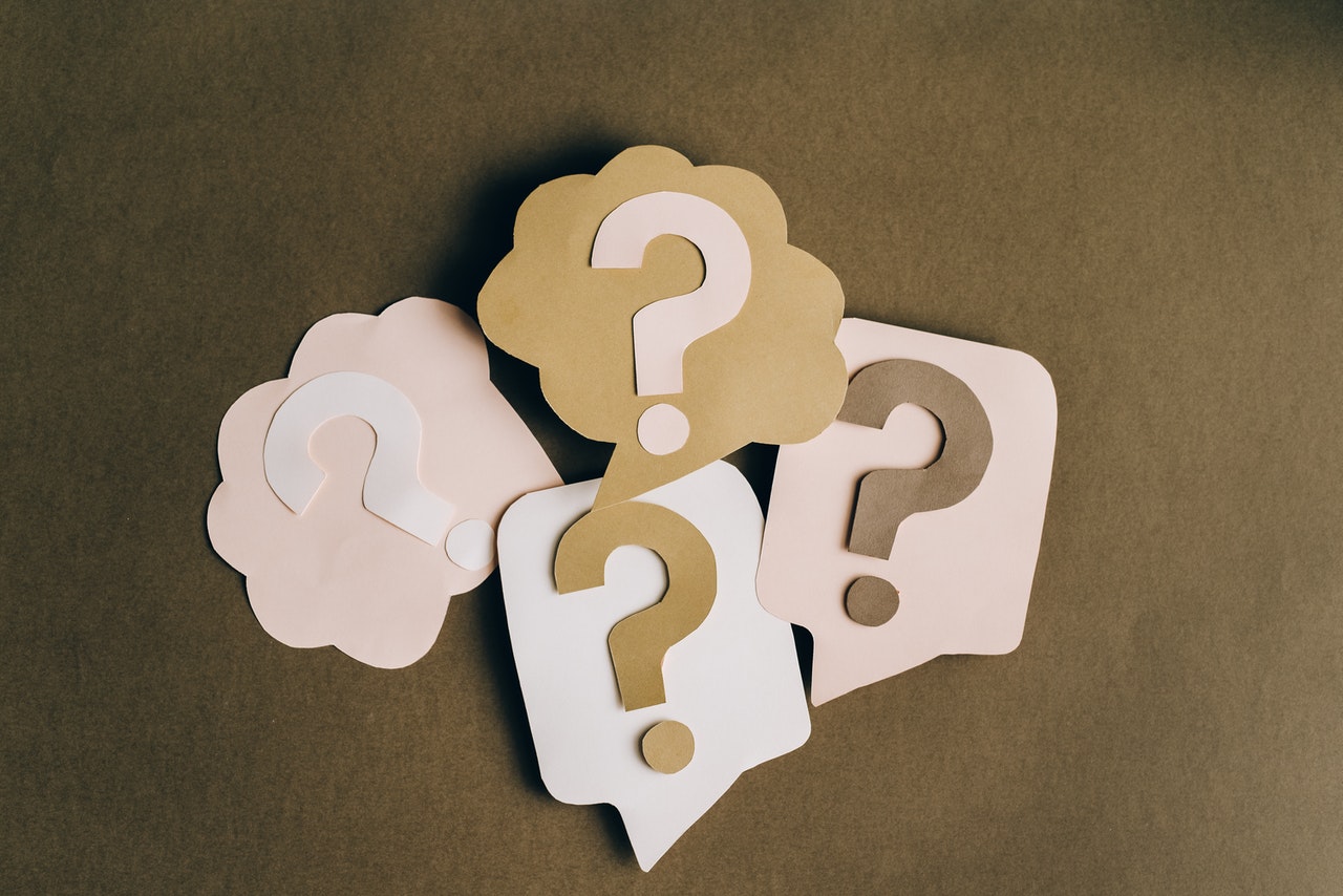 Four pastel speech bubbles with question marks, symbolizing unanswered DNS queries and NXDOMAIN responses