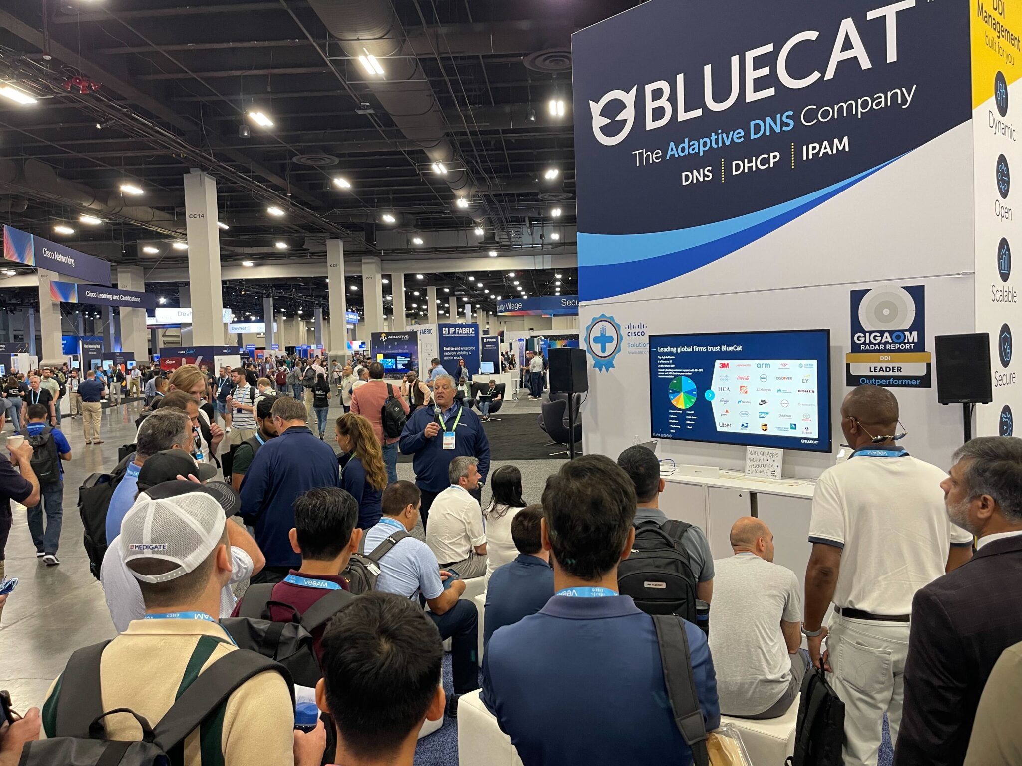 A crowd gathered for a booth presentation at BlueCat