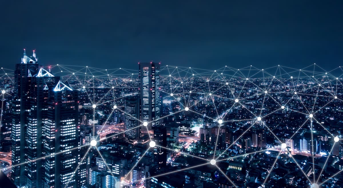 A vibrant city skyline illuminated at night, symbolizing global connectivity through the internet and technology.